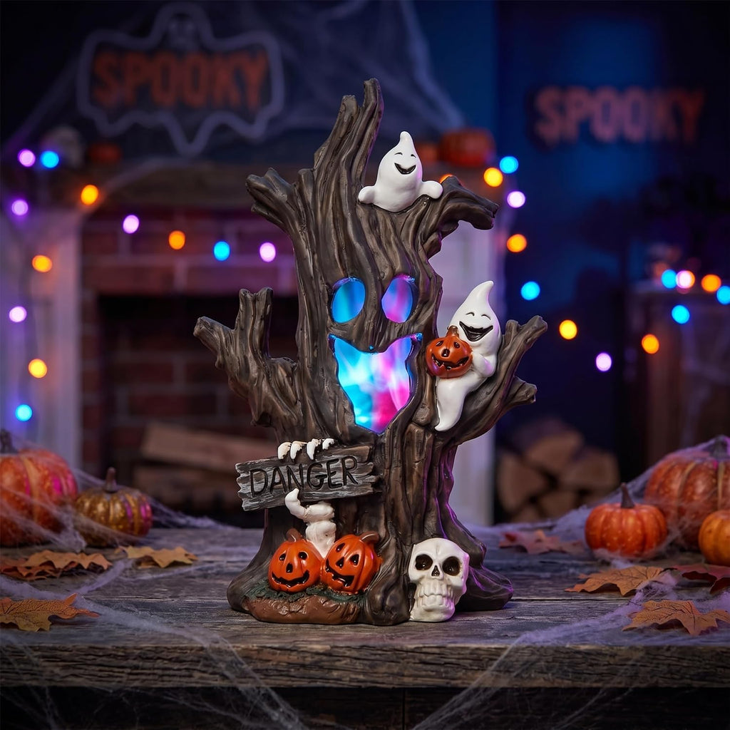 Halloween Spooky Tree Lighted Figurine glowing with color-changing LED lights on a mantel