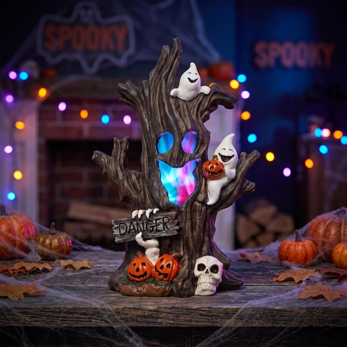 Halloween Spooky Tree Lighted Figurine glowing with color-changing LED lights on a mantel